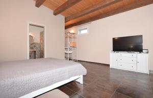 a bedroom with a bed and a flat screen tv at A Valata di Donnafugata in Ragusa