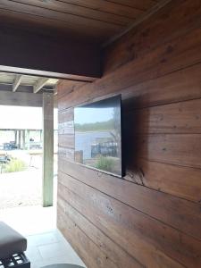 a television on a wooden wall in a room at 127 Banfill in Santa Rosa Beach