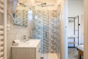 a bathroom with a sink and a shower at La Corte Rooms Pisa in Pisa