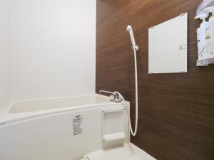 a bathroom with a white sink and a mirror at Hikari-Private House in Tokyo