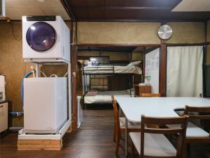 a room with two bunk beds and a tv at Hikari-Private House in Tokyo