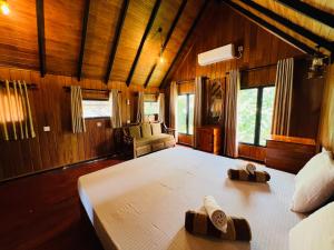 a bedroom with a large bed in a room at Sigiriya Coconut Shade Resort in Sigiriya