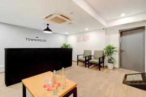 an office with a table with bottles on it at Hotel O Crowninn in Faridabad