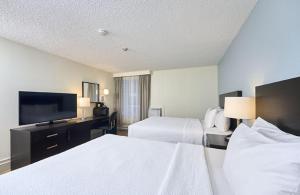 a hotel room with two beds and a flat screen tv at Canad Inns Destination Centre Windsor Park in Winnipeg +23 photos