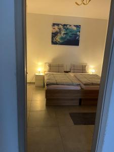 a bedroom with two beds and two lamps on tables at Ferienwohnung in Bochum