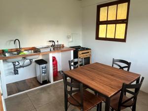 a kitchen with a wooden table and a sink at Atea Fare Pāmata'i in Faaa +17 photos