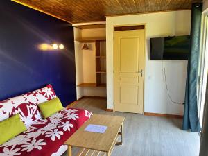 a living room with a couch and a table at Atea Fare Pāmata'i in Faaa