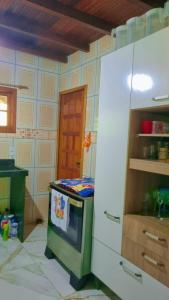 a kitchen with a stove top oven in a room at Sitio Ziriguidum in Nova Friburgo