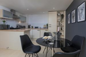 a kitchen and dining room with a table and chairs at The Midnight Parlour in Leeds +32 photos