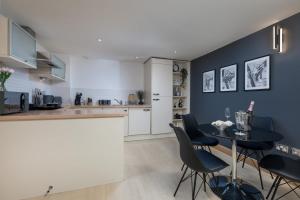 a kitchen with a black table and chairs at The Midnight Parlour in Leeds