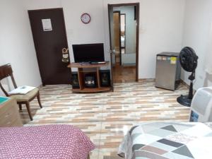 a room with a bed and a television on a floor at Casa Turistica Andy in Cali