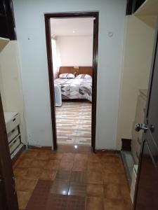 a hallway with a bed in a bedroom at Casa Turistica Andy in Cali