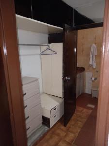 a room with a closet with white cabinets and a door at Casa Turistica Andy in Cali +68 photos