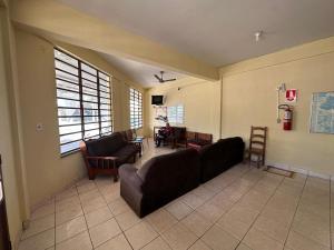 a living room with a couch and a table at Hotel Ideal in Boa Vista
