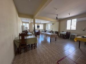 a dining room with tables and chairs and windows at Hotel Ideal in Boa Vista