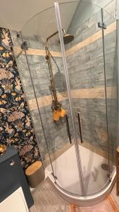 a shower with a glass enclosure in a bathroom at Garden Galley Nook in Sproatley +11 photos