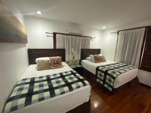 a bedroom with two beds and a window at Coras Place Bacalar Lagoon front in Bacalar +41 photos