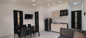 a kitchen with a table and chairs in a room at Villa Luna Hotel-Eventos in Carmen de Apicalá