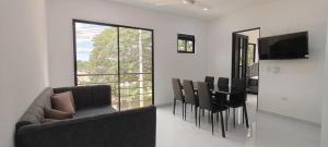 a living room with a couch and a table and chairs at Villa Luna Hotel-Eventos in Carmen de Apicalá