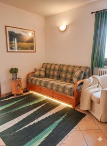 a living room with a couch and a chair at Lo chalet di Lucky in Campodolcino