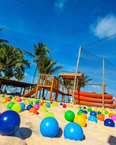 a beach with a bunch of balls in the sand at Arraial D'ajuda Eco Resort in Arraial d'Ajuda