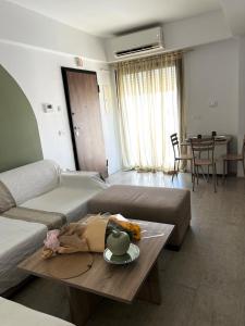 a living room with a couch and a table at Comfortable and Fresh Apartment in Tunis +13 photos