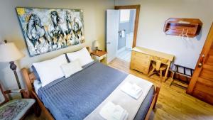 a bedroom with a bed and a piano at Auberge Ayer's Cliff in Ayers Cliff