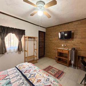 a bedroom with a bed and a ceiling fan at West Refugio in San Juan del Río