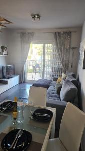 a living room with a couch and a table at Lazy Wave Apartment in Torrevieja