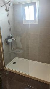 a shower with a glass door in a bathroom at Lazy Wave Apartment in Torrevieja +10 photos