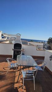 a table and chairs on top of a roof at Lazy Wave Apartment in Torrevieja