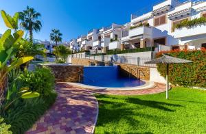 a villa with a swimming pool in a resort at Lazy Wave Apartment in Torrevieja