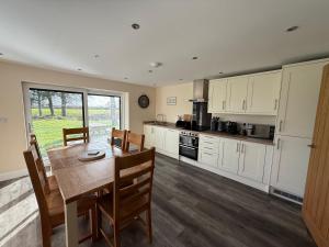 a kitchen with a wooden table and a dining room at Four Bedroom House With Private Pool - Stunning countryside location with parking close to Chester City Centre in Chester
