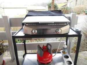 a grill sitting on a table on a porch at Gite au pied de la montagne avec tous commerces in Arette