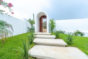 a white house with stairs leading to a door at Casa Nami in Puerto Escondido +73 photos