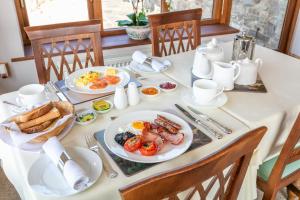 a table with plates of breakfast food on it at Beaconsview B&B in Brecon