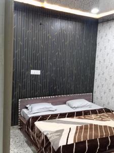 a bedroom with two beds and a black wall at Hotel p p inn in Agra