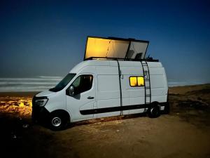 a white van with a box on top of it at Van aménagé tout confort in Tamaris