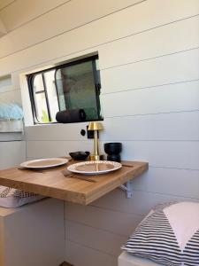 a table in a tiny house with a sink at Van aménagé tout confort in Tamaris