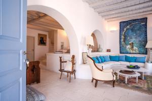 a living room with a couch and a table at Elegance Villa in Platis Gialos