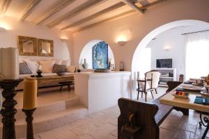 a living room with a couch and a table at Elegance Villa in Platis Gialos