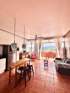 a living room with a table and a couch at Boutique Hotel Casa de Lis, Turrialba in Turrialba