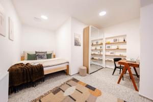 a bedroom with a bed and a desk at Rezidence Rotter in Králíky