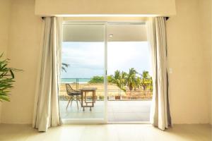 a sliding glass door with a view of the ocean at Casa Nami in Puerto Escondido