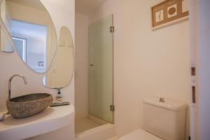 a bathroom with a sink and a toilet and a mirror at Elegance Villa in Platis Gialos +65 photos