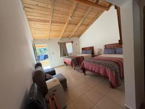 a large room with two beds and a couch at Hotel Mi Lindo Chihuahua in Areponapuchi