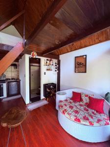 a living room with a couch and a table at Chalé Sertão da Boa Vista in Rio Claro