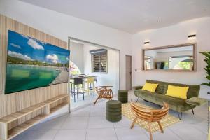 a living room with a couch and a table at Résidence Les A'Rhum de l'Anse in Les Trois-Îlets
