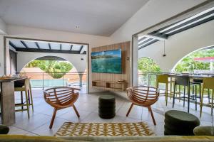 an open living room with a view of a pool at Résidence Les A'Rhum de l'Anse in Les Trois-Îlets