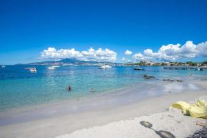 a beach with people swimming in the water at Résidence Les A'Rhum de l'Anse in Les Trois-Îlets +41 photos
